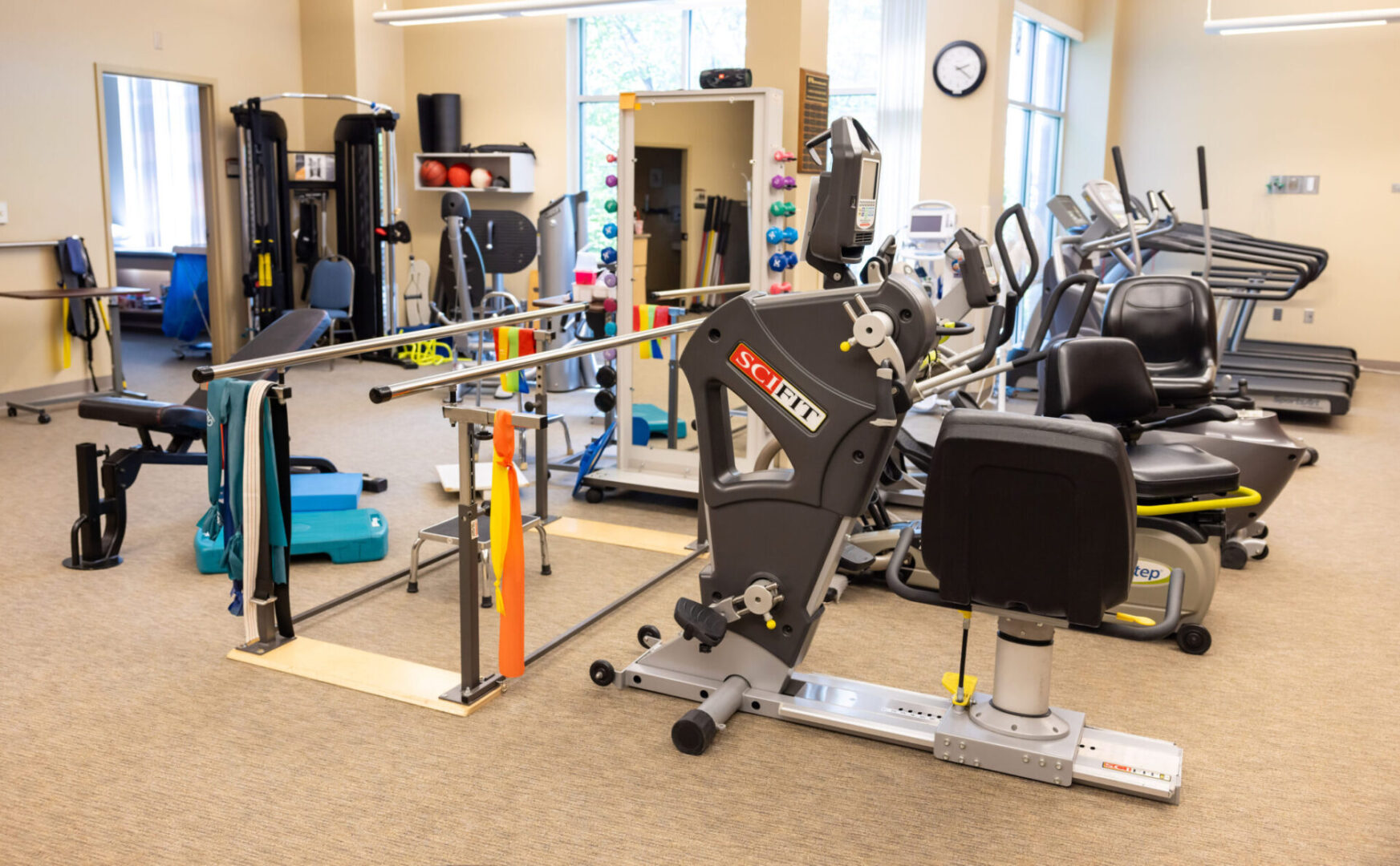 A gym with many different equipment in it