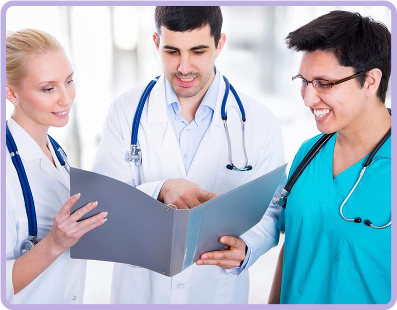 Three doctors are looking at a folder of papers.