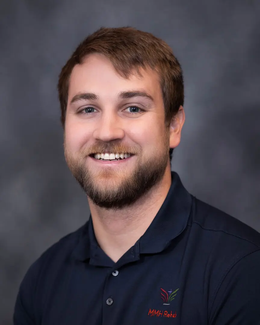 A man with a beard is smiling for the camera.