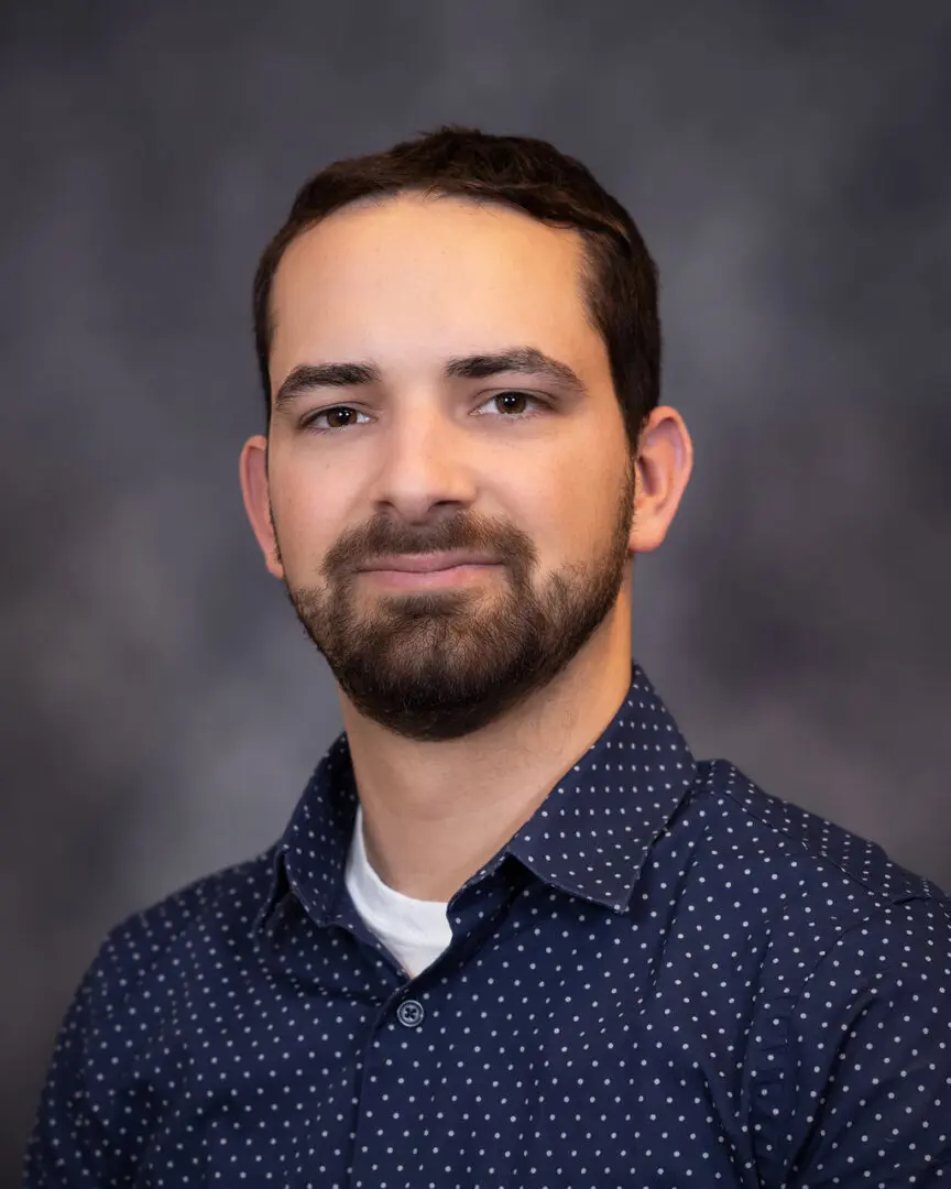 A man with a beard and blue shirt