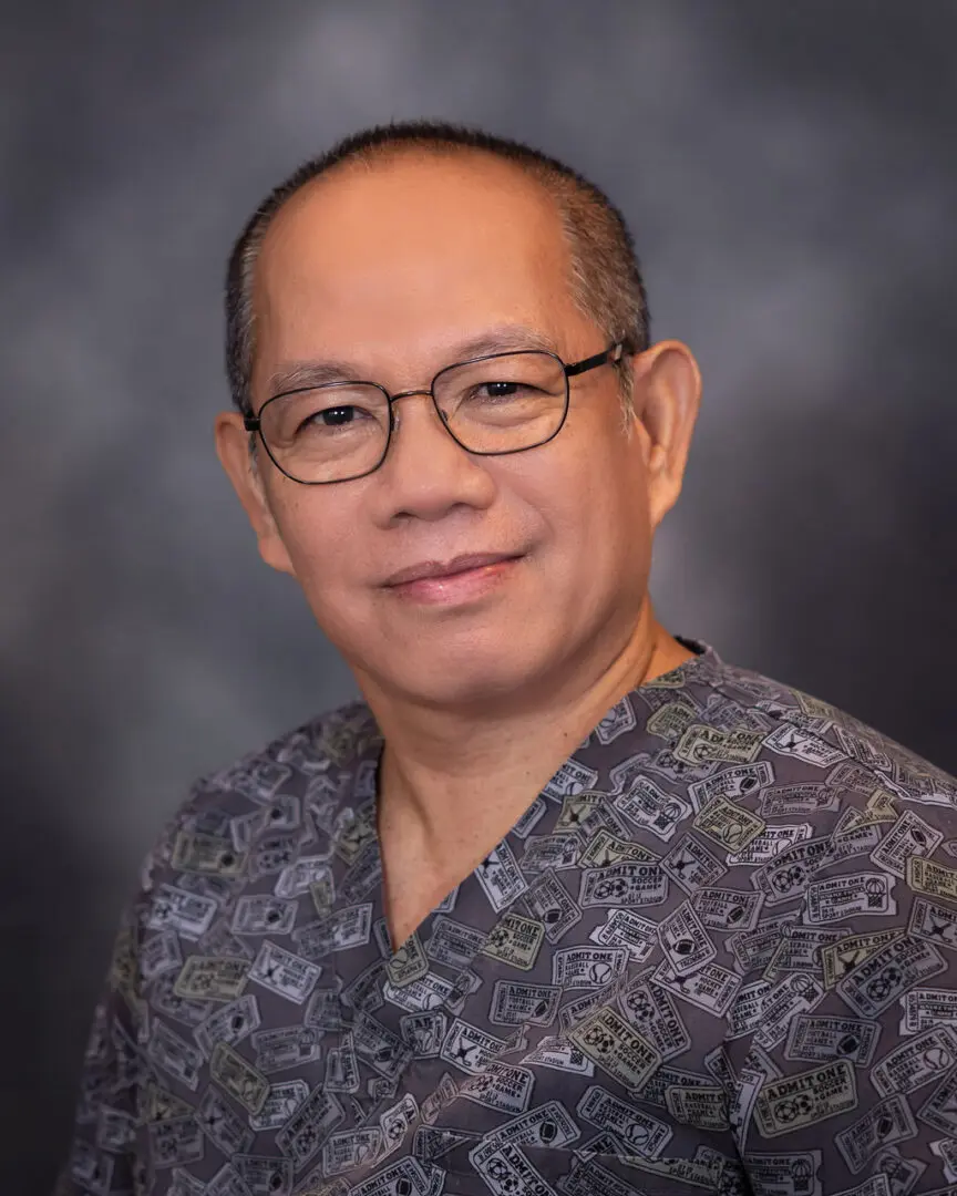 A man with glasses and a floral shirt.